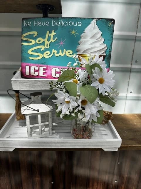 Vintage Soft Serve Ice Cream sign with a white daisy arrangement on the truck's serving shelf